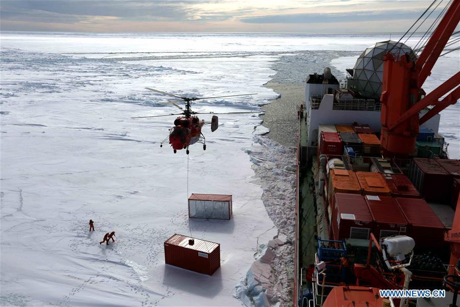 Members of the research team use the helicopter to unload cargo at the roadstead off the Zhongshan station in Antarctica, Dec. 1, 2018. China\'s research icebreaker Xuelong arrived at the roadstead off the Zhongshan station in Antarctica on Saturday. Unloading work has been carried out. Xuelong carrying a research team set sail from Shanghai on Nov. 2, beginning the country\'s 35th Antarctic expedition. (Xinhua/Liu Shiping)