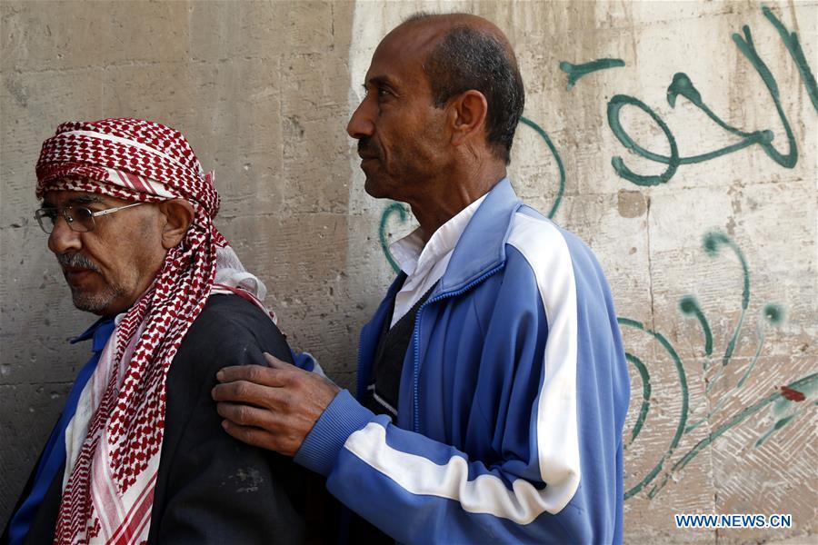 Ahmed al-Sharafi (R) stands in line to receive food aid at a charity center in Sanaa, Yemen, on Dec. 9, 2018. An estimated 85,000 children under the age of five may have died from extreme hunger between April 2015 and October 2018, according to the latest data released by Save the Children, an international organization for children\'s rights. (Xinhua/Mohammed Mohammed)