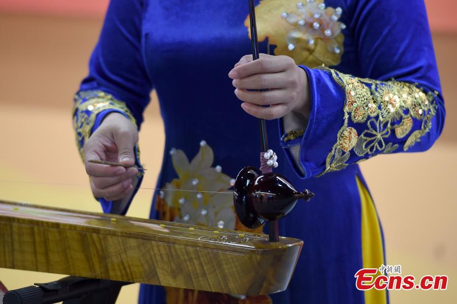 A woman from the Jing people plays a musical instrument at an exhibition to mark the 60th anniversary of the establishment of the Guangxi Zhuang Autonomous Region in the region’s capital Nanning City, Dec. 10, 2018. Established in 1958 as an autonomous region, Guangxi has a population of 56 million, including more than 20 million who identify as ethnic minorities. It tops in China’s provincial-level regions in minority populations. (Photo: China News Service/Hou Yu)