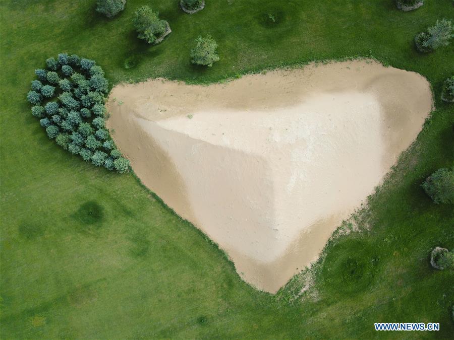 Aerial photo taken on Aug. 1, 2018 shows a sand dune in the Kubuqi Desert, north China\'s Inner Mongolia Autonomous Region. Colors make our world bright and beautiful. In 2018, Xinhua photographers across China explored views from the sky with drones. Here are these drone photos with amazing colors. (Xinhua/Xing Guangli)