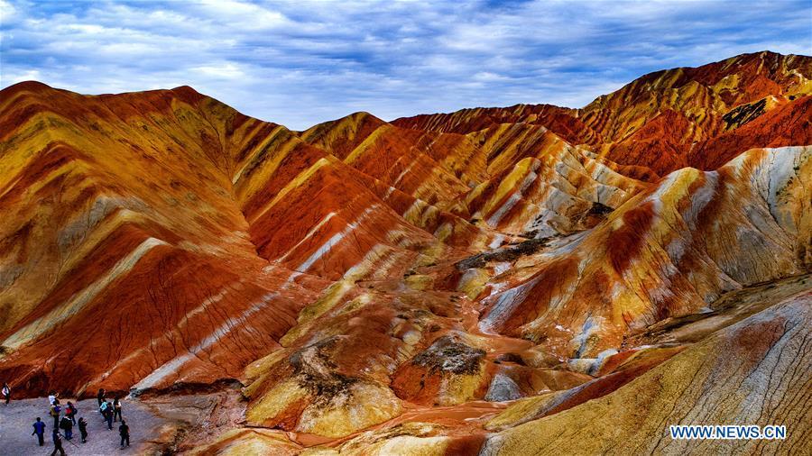 Aerial photo taken on Sept. 5, 2018 shows people visiting the Danxia National Geological Park in Zhangye, northwest China\'s Gansu Province. Colors make our world bright and beautiful. In 2018, Xinhua photographers across China explored views from the sky with drones. Here are these drone photos with amazing colors. (Xinhua/Tao Ming)