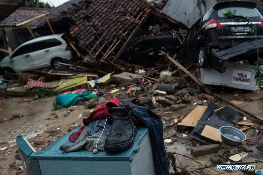 Clothes and a shoe are seen among debris after a tsunami hit Sunda Strait in Pandeglang, Banten province, in Indonesia, Dec. 23, 2018. The total casualty of a tsunami triggered by the eruption of Krakatau Child volcano has increased to 222 people in coastal areas of Sunda Strait of western Indonesia, disaster agency official said here on Sunday. The catastrophe killed at least 222 people, wounded at least 843 ones and collapsed a total of 556 houses and nine hotels, and caused damages to scores of ships. (Xinhua/Veri Sanovri)