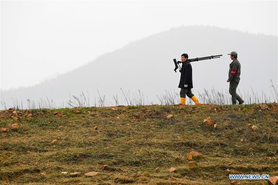 Wang Sanyi (L) patrols for migrant-bird protection in Caizi Lake wetland, Anqing, in east China\'s Anhui Province, Dec. 22, 2018. Wang Sanyi, 69, founded the Caizi Lake wetland ecological protection association with more than 300 members in 2010. Some villagers who used to be hunters now join the association, becoming volunteers to protect migrant birds. With the help of the association, the ecological environment of Caizi Lake wetland has been improved in recent years. Thanks to the efforts of protection, more and more migrant birds are seen here overwintering. \