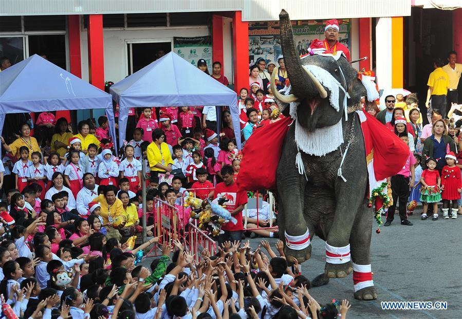 An elephant distributes gifts to students during Christmas celebrations at a school in Ayutthaya province, Thailand, Dec. 24, 2018. The annual event is held to celebrate Christmas and promote tourism in Ayutthaya. (Xinhua/Rachen Sageamsak)