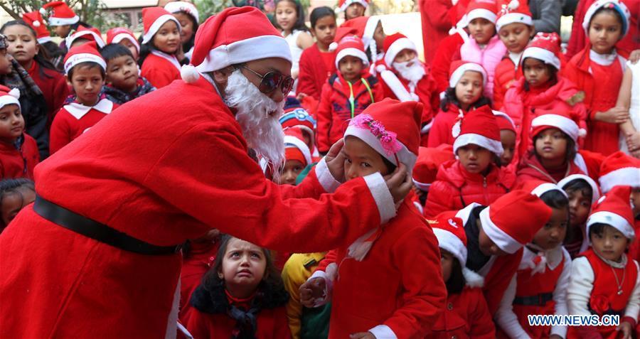 A Nepalese teacher dressed up as Santa Claus participates in celebration of Christmas at a local school in Kathmandu, Nepal, on Dec. 24, 2018. (Xinhua/Sunil Sharma)