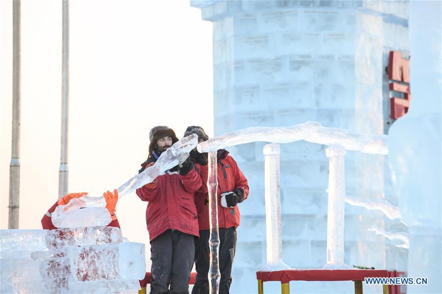 Contestants carve an ice sculpture during an international ice sculpture competition in Harbin, capital of northeast China\'s Heilongjiang Province, Jan. 3, 2019. (Xinhua/Wang Song)