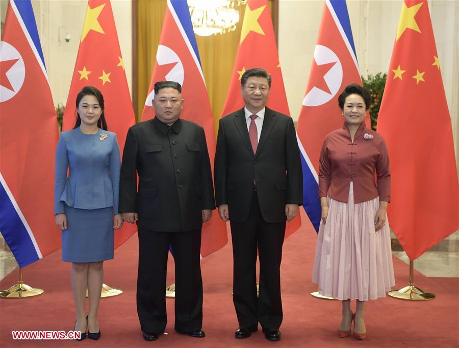 Xi Jinping (2nd R), general secretary of the Central Committee of the Communist Party of China and Chinese president, and his wife Peng Liyuan (1st R) pose for photos with Kim Jong Un (2nd L), chairman of the Workers\' Party of Korea and chairman of the State Affairs Commission of the Democratic People\'s Republic of Korea, and his wife Ri Sol Ju in Beijing, capital of China, Jan. 8, 2019. Xi Jinping on Tuesday held talks with Kim Jong Un, who arrived in Beijing on the same day for a visit to China. Before the talks, Xi Jinping held a welcoming ceremony for Kim Jong Un at the Great Hall of the People in Beijing. (Xinhua/Li Xueren)