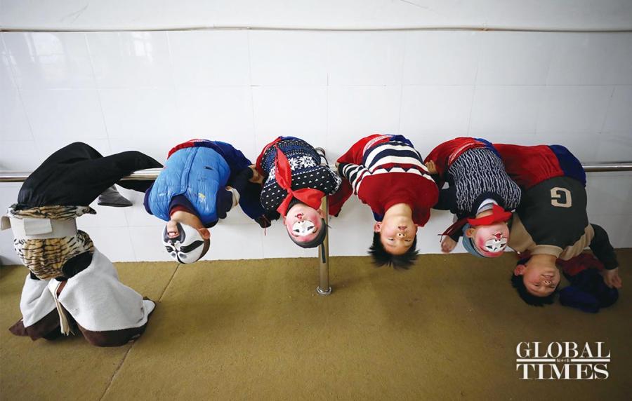 Students arch their backs during a Peking Opera training session at the Xichang Primary School. (Photos: Yang Hui/GT)