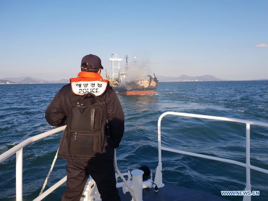 A marine policeman looks for a missing Chinese in the southwest waters of South Korea, Jan. 17, 2019. A fishing boat caught fire in the southwest waters of South Korea on Thursday morning, leaving one person dead, one missing and one wounded. (Xinhua)