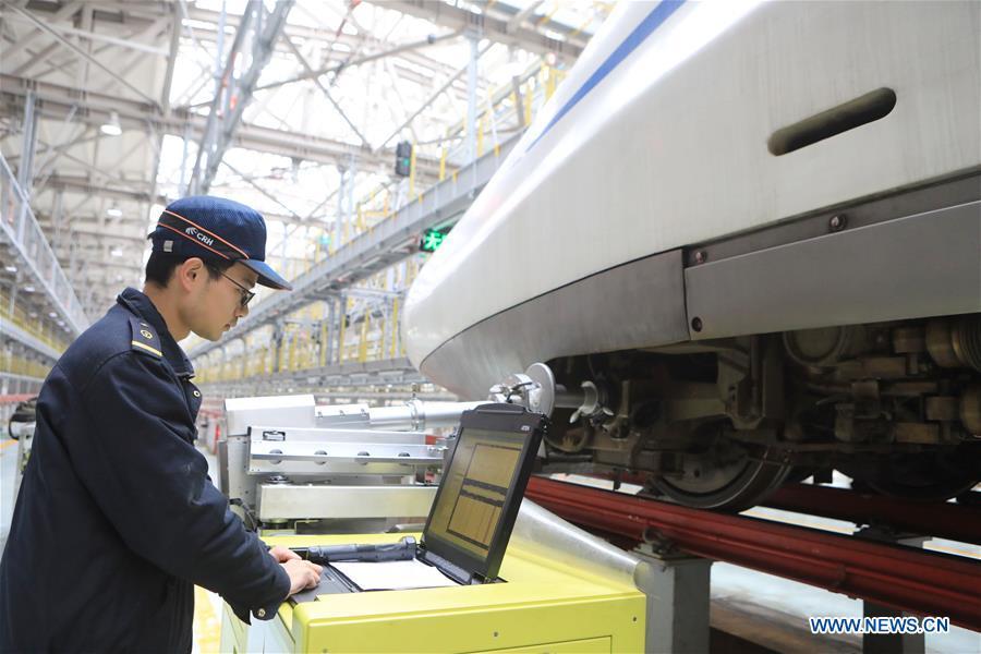 Zhang Yuqi conducts a ultrasound check on a bullet train at a maintenance center in Guiyang, capital of southwest China\'s Guizhou Province, Jan. 30, 2019. As a model train hobbyist, 27-year-old Zhang Yuqi has made and collected more than a hundred model trains. Zhang is also a bullet train mechanic responsible for checking bullet trains during the Spring Festival travel rush at a maintenance center in Guiyang of Guizhou Province. Despite heavy work load and work pressure, Zhang said he is dedicated to ensuring the safety of bullet trains. (Xinhua/Ou Dongqu)