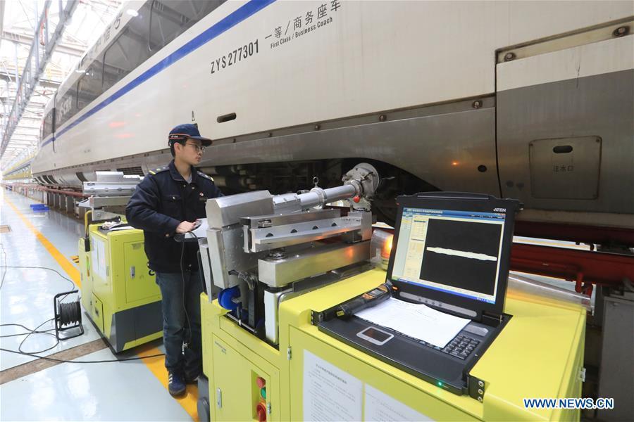 Zhang Yuqi conducts a ultrasound check on a bullet train at a maintenance center in Guiyang, capital of southwest China\'s Guizhou Province, Jan. 30, 2019. As a model train hobbyist, 27-year-old Zhang Yuqi has made and collected more than a hundred model trains. Zhang is also a bullet train mechanic responsible for checking bullet trains during the Spring Festival travel rush at a maintenance center in Guiyang of Guizhou Province. Despite heavy work load and work pressure, Zhang said he is dedicated to ensuring the safety of bullet trains. (Xinhua/Ou Dongqu)