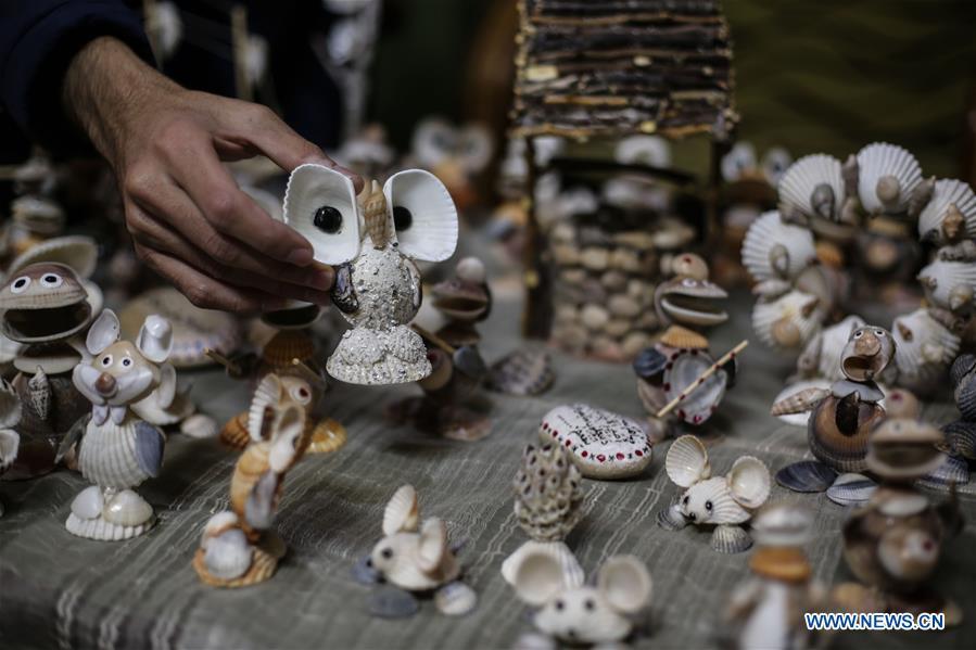 Palestinian young man Ahmed al-Madhoun, 31, displays art pieces he made with seashells at his house in Gaza City, on Feb. 10, 2019. A Palestinian young man from Gaza turns seashells into beautiful artifacts that adorn his home to satisfy his passion for this type of art. Using seashells he collects from Gaza beaches, 31-year-old Ahmed al-Madhoun makes various art pieces such as animals, birds and some funny characters. Al-Madhoun, who holds a college degree in radio and television engineering and works for a local telecommunication company, has been collecting multiple forms of seashells from the Gaza seashore for more than four years. The young man began the hobby of seashell art about a year and a half ago, and he already made large numbers of art pieces. (Xinhua/Stringer)