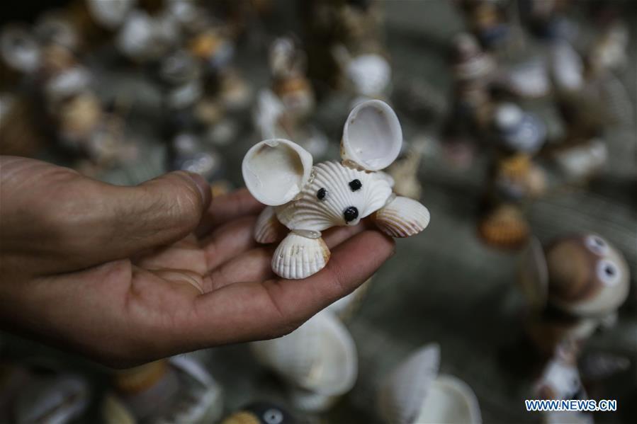 Palestinian young man Ahmed al-Madhoun, 31, displays an art piece he made with seashells at his house in Gaza City, on Feb. 10, 2019. A Palestinian young man from Gaza turns seashells into beautiful artifacts that adorn his home to satisfy his passion for this type of art. Using seashells he collects from Gaza beaches, 31-year-old Ahmed al-Madhoun makes various art pieces such as animals, birds and some funny characters. Al-Madhoun, who holds a college degree in radio and television engineering and works for a local telecommunication company, has been collecting multiple forms of seashells from the Gaza seashore for more than four years. The young man began the hobby of seashell art about a year and a half ago, and he already made large numbers of art pieces.  (Xinhua/Stringer)
