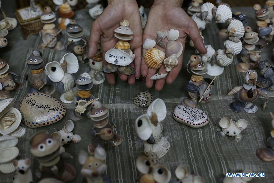 Palestinian young man Ahmed al-Madhoun, 31, displays art pieces he made with seashells at his house in Gaza City, on Feb. 10, 2019. A Palestinian young man from Gaza turns seashells into beautiful artifacts that adorn his home to satisfy his passion for this type of art. Using seashells he collects from Gaza beaches, 31-year-old Ahmed al-Madhoun makes various art pieces such as animals, birds and some funny characters. Al-Madhoun, who holds a college degree in radio and television engineering and works for a local telecommunication company, has been collecting multiple forms of seashells from the Gaza seashore for more than four years. The young man began the hobby of seashell art about a year and a half ago, and he already made large numbers of art pieces.  (Xinhua/Stringer)