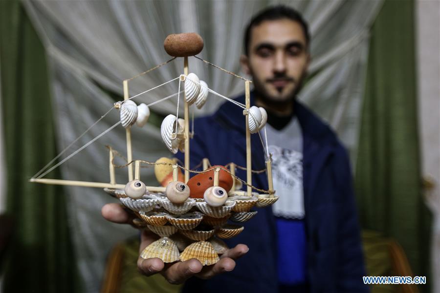 Palestinian young man Ahmed al-Madhoun, 31, displays an art piece he made with seashells at his house in Gaza City, on Feb. 10, 2019. A Palestinian young man from Gaza turns seashells into beautiful artifacts that adorn his home to satisfy his passion for this type of art. Using seashells he collects from Gaza beaches, 31-year-old Ahmed al-Madhoun makes various art pieces such as animals, birds and some funny characters. Al-Madhoun, who holds a college degree in radio and television engineering and works for a local telecommunication company, has been collecting multiple forms of seashells from the Gaza seashore for more than four years. The young man began the hobby of seashell art about a year and a half ago, and he already made large numbers of art pieces. (Xinhua/Stringer)