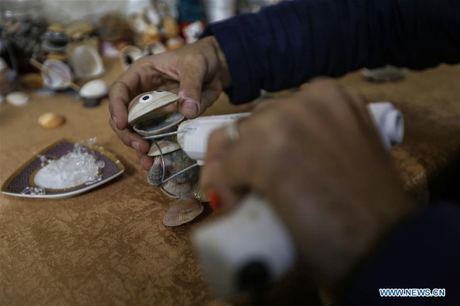 Palestinian young man Ahmed al-Madhoun, 31, makes an art piece with seashells at his house in Gaza City, on Feb. 10, 2019. A Palestinian young man from Gaza turns seashells into beautiful artifacts that adorn his home to satisfy his passion for this type of art. Using seashells he collects from Gaza beaches, 31-year-old Ahmed al-Madhoun makes various art pieces such as animals, birds and some funny characters. Al-Madhoun, who holds a college degree in radio and television engineering and works for a local telecommunication company, has been collecting multiple forms of seashells from the Gaza seashore for more than four years. The young man began the hobby of seashell art about a year and a half ago, and he already made large numbers of art pieces.  (Xinhua/Stringer)