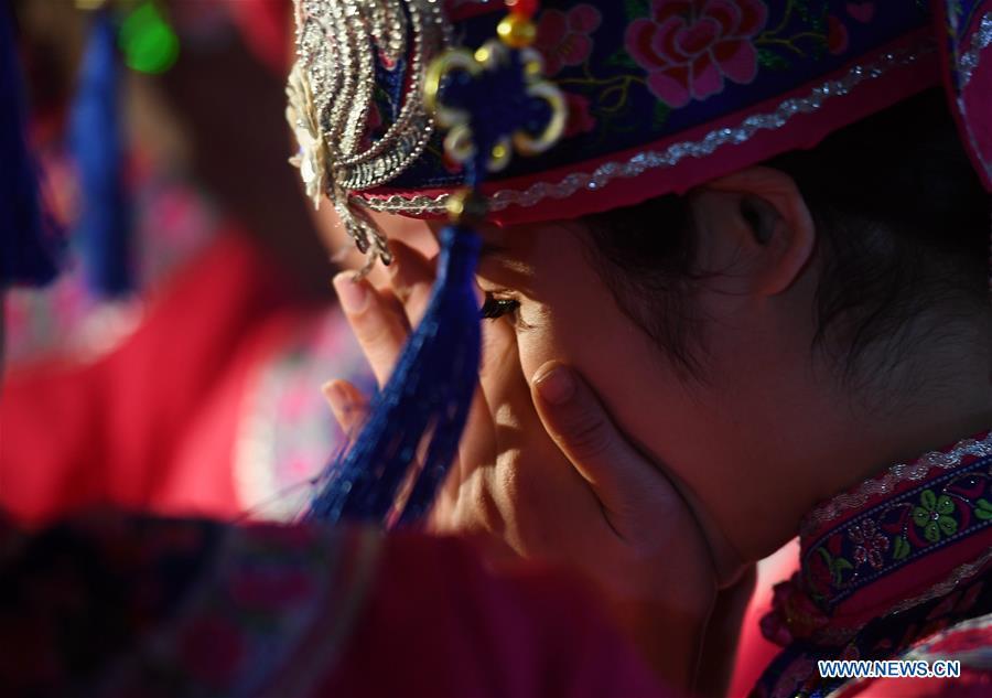 The bride is seen at a wedding ceremony in Mianhua Village of Siba Township of Luocheng Mulao Autonomous County, south China\'s Guangxi Zhuang Autonomous Region, March 17, 2019. A traditional wedding ceremony of the Mulao ethnic group is held here on Sunday. (Xinhua/Meng Zengshi)