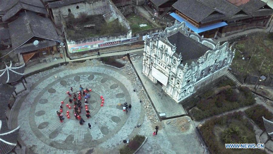 Aerial photo shows villagers of Santangmen Village watching a movie in Santangmen Village of Benchu Town, Tianzhu County of Miao and Dong Autonomous Prefecture of Qiandongnan, southwest China\'s Guizhou Province, March 19, 2019. Local authority in Tianzhu County established special fund to show movies in rural areas. In 2018, a total of 14 voluntary projectionists in Tianzhu showed 3,979 movies in villages within the county. (Xinhua/Ou Dongqu)