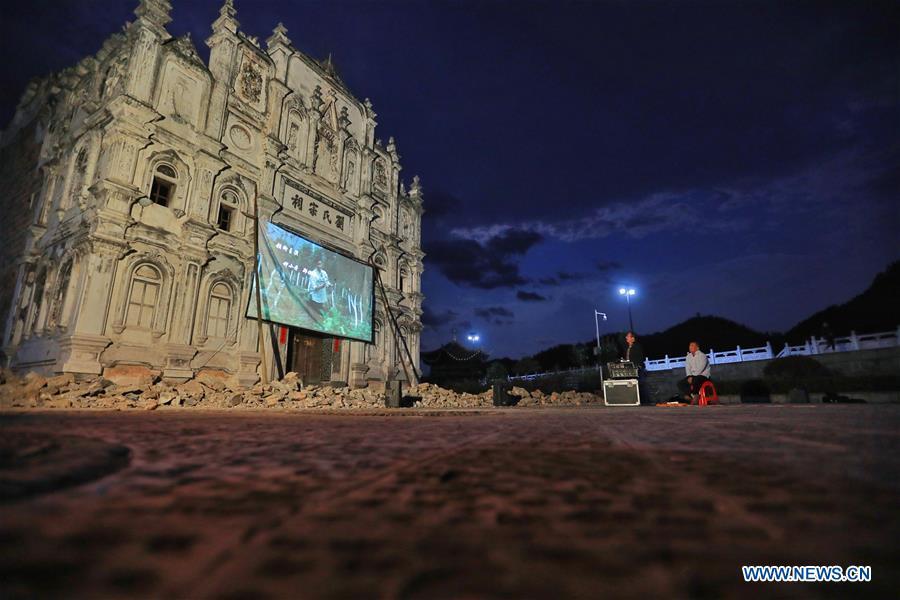 Huang Yiyin (L) and his assistant Wang Yangqing screen a movie in Santangmen Village of Benchu Town, Tianzhu County of Miao and Dong Autonomous Prefecture of Qiandongnan, southwest China\'s Guizhou Province, March 19, 2019. Local authority in Tianzhu County established special fund to show movies in rural areas. In 2018, a total of 14 voluntary projectionists in Tianzhu showed 3,979 movies in villages within the county. (Xinhua/Ou Dongqu)