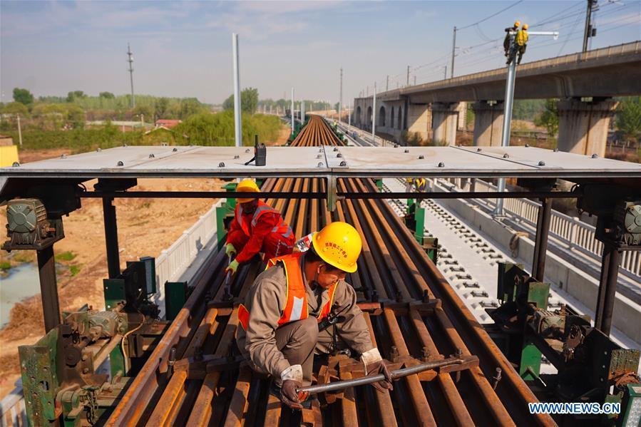 Builders of China Railway 12th Bureau Group work on the Liying section of the Beijing-Xiongan intercity railway, April 15, 2019. Track-laying work of the Beijing-Xiongan intercity railway began on Monday. (Xinhua/Xing Guangli)