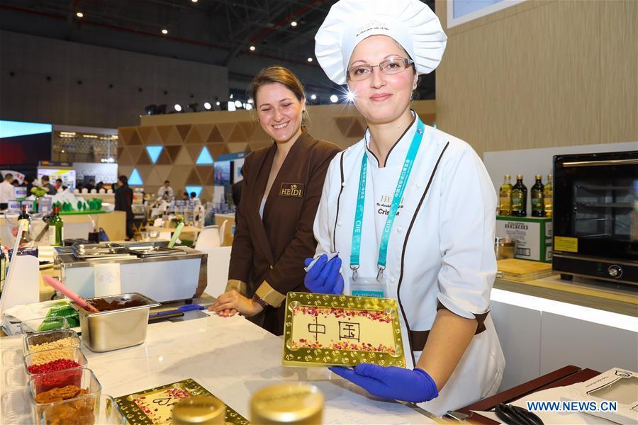 Exhibitors of Swiss chocolate maker Heidi shows a bar of chocolate with the pattern reading \