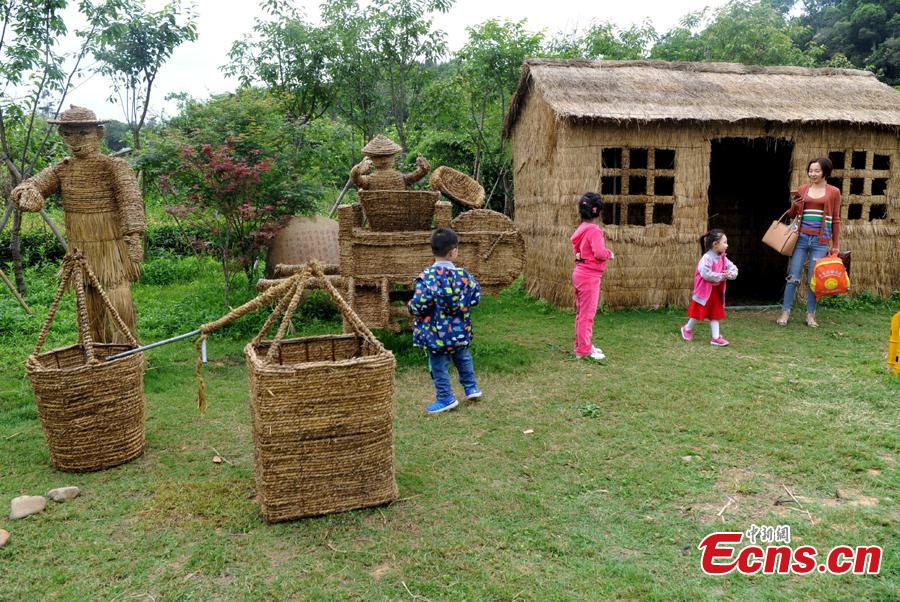 Straw-made creations including an elephant, a kangaroo, a harvester and a tractor in the Huatian Xigu scenic area, known for its rural charms, in Chongqing, April 28, 2019. The eye-catching creations are a particular draw for tourists. (Photo: China News Service/Chen Chao)