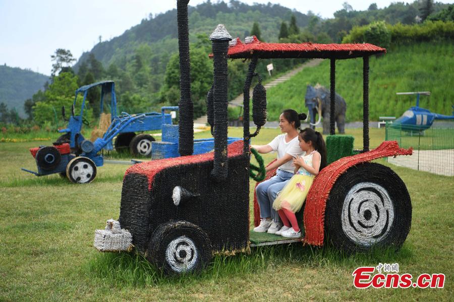 Straw-made creations including an elephant, a kangaroo, a harvester and a tractor in the Huatian Xigu scenic area, known for its rural charms, in Chongqing, April 28, 2019. The eye-catching creations are a particular draw for tourists. (Photo: China News Service/Chen Chao)