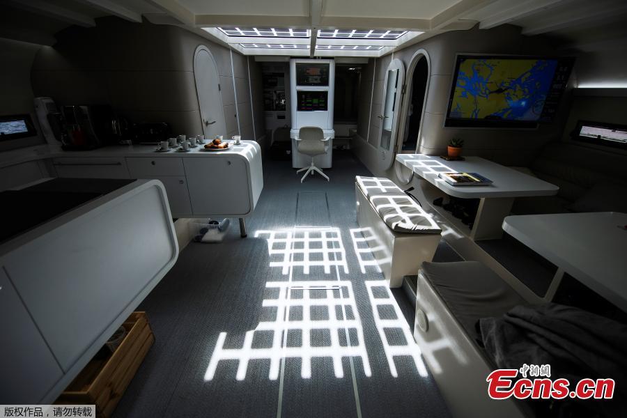 A picture taken on May 28, 2019 shows the interior of the main cabin onboard the self-energy producing multihull \