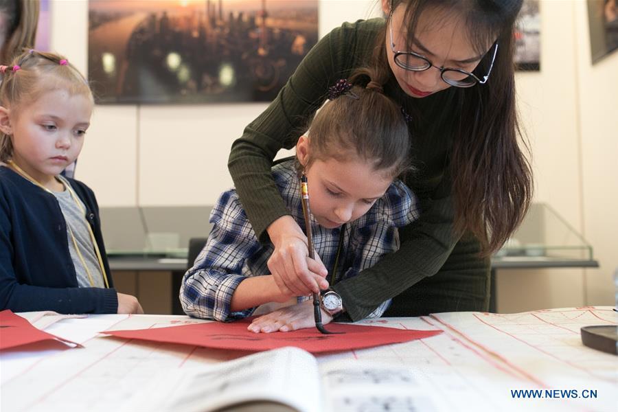 A Russian girl learns Chinese calligraphy at a Spring Festival celebration held by the China Culture Center in Moscow, Russia, Feb. 2, 2019. (Xinhua/Bai Xueqi)
