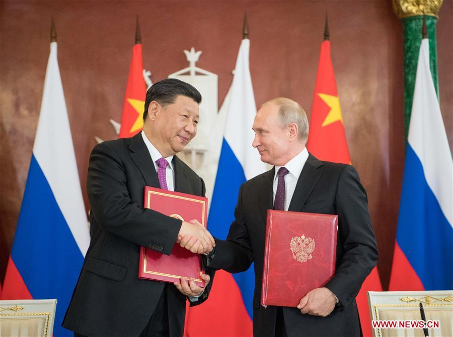 Chinese President Xi Jinping (L) and his Russian counterpart Vladimir Putin sign the statements on elevating bilateral ties to the comprehensive strategic partnership of coordination for a new era and on strengthening contemporary global strategic stability, and witness the signing of a number of cooperation documents, after their talks in Moscow, Russia, June 5, 2019. Xi Jinping held talks with Vladimir Putin at the Kremlin in Moscow on Wednesday. (Xinhua/Li Xueren)