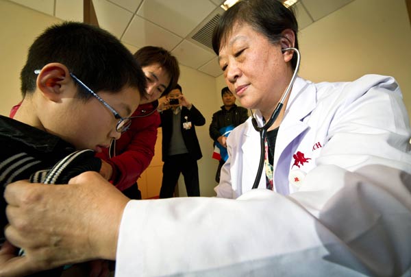 A doctor treats a boy at Tianjin New Century Children's Hospital in Tianjin. The hospital, which opened last year, is the first private hospital for children in the city. Yue Yuewei / Xinhua A doctor treats a boy at Tianjin New Century Children's Hospital in Tianjin. The hospital, which opened last year, is the first private hospital for children in the city. Yue Yuewei / Xinhua